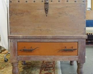 1048	DOME TOP TRUNK ON A FRAME, BASE HAS DRAWER, WROUGHT IRON HARDWARE, COTTER PIN HINGES, DRAWER PULLS ARE IN THE FORM OF ALLIGATORS, HAS LEATHER COVERED TOP & DRAWER FRONT, 46 1/2 IN HIGH X 40 IN X 23 IN
