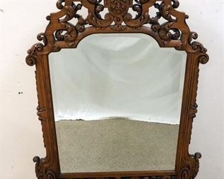 1143	ORNATE HIGHLY CARVED FREE STANDING BEVELED MIRROR. 58 IN HIGH X 37 IN WIDE
