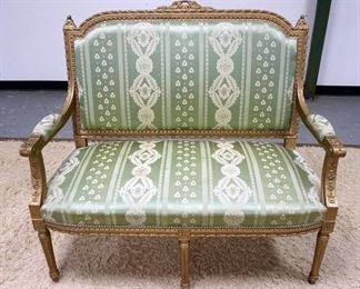 1159	CARVED UPHOLSTERED PAINT DECORATED ITALIAN SETTEE. 46 IN X 42 IN HIGH. HAS SOME STAINING ON UPHOLSTERY
