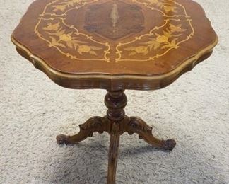 1165	LAMP TABLE WITH INLAID TOP, TURNED PEDESTAL, AND CARVED FEET. FINISH WEAR ON TOP, 28 IN X 29 1/4 IN HIGH
