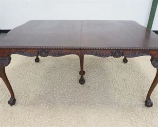 1177	CHIPENDALE STYLE DINING TABLE WITH 5 LEAVES. SKIRTED FINISH WORN, SOME VENEER LOSS. 48 IN X 72 IN X 30 1/2 IN, LEAVES 9 1/2 IN
