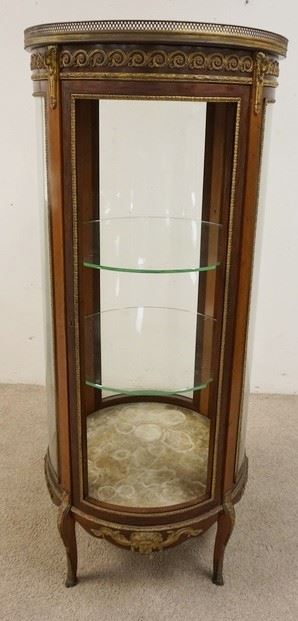 1183	FRENCH ROUND VICTORIAN MARBLE TOP CURIO WITH BRONZE BANDING AND MOUNTS OF RAMS HEADS AND HOOVES. GLASS MISSING ON FRONT DOOR. 25 IN X 59 IN
