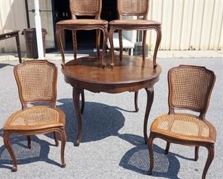 1191	ITALIAN WALNUT TABLE WITH 4 CANE CHAIRS, FINISH WORN AND CANE STRESSED ON SOME CHAIRS
