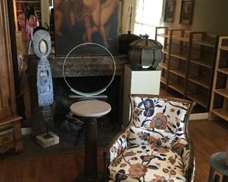 Matching Chintz Print Arm Chair - Large Cherub Artwork over fireplace - Marble Top Plant Stand - Metal Aztec Standing Figure