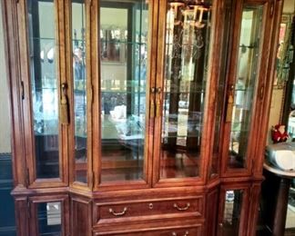 Beautiful lighted china cabinet w/beveled glass, angled doors, glass shelves and four drawers.