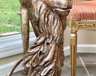 Close up of French glass top table with lion motif legs