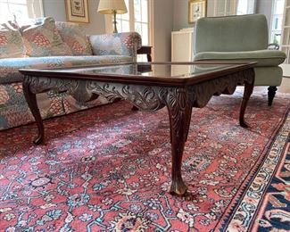 Carved wood cocktail table with ball and claw feet and glass top. Beautiful as is or paint for a more modern or coastal chic look and feel. Measures 40" x 40" x 17.5" H. Photo 1 of 2.