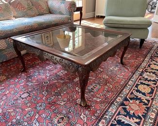 Carved wood cocktail table with ball and claw feet and glass top. Beautiful as is or paint for a more modern or coastal chic look and feel. Measures 40" x 40" x 17.5" H. Photo 2 of 2.