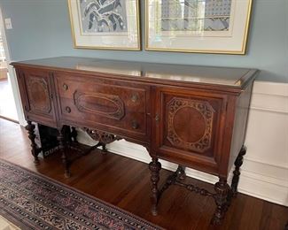 Antique Jacobean-style mahogany buffet with carved wood turned legs and floral cartouche detailing. Circa 1920. Measures 72" W x 22"D x 38"H. Photo 1 of 2.