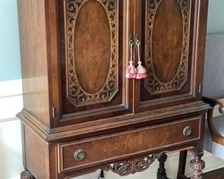 Antique Jacobean-style mahogany cabinet sideboard with turned legs and floral cartouche detailing. Circa 1920. Measures 38" W x 58.5"H x 16" D.