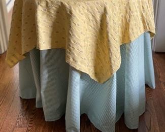 Particle board side table with blue and yellow draping. Measures 23" H x 20" D.