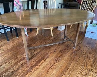 Drop leaf oval dining room table. Measures 66" L x 20.25" W x 29.5" H. Width extends to 44" when both sides are open.