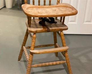 Vintage wood highchair with turned wood detailing.