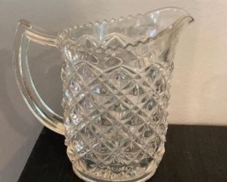 Depression glass pitcher. Measures 6" H.