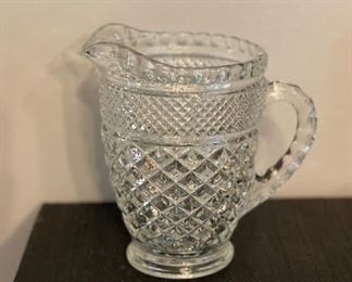 Depression glass pitcher. Measures 6" H.
