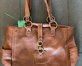 Claudia leather handle with brass horse bit clip. Made in Italy.