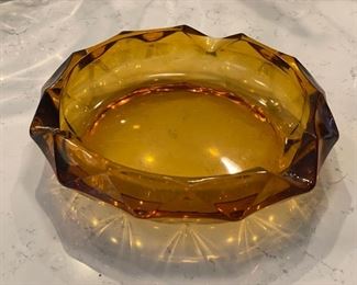 Vintage 10" D amber glass ashtray.