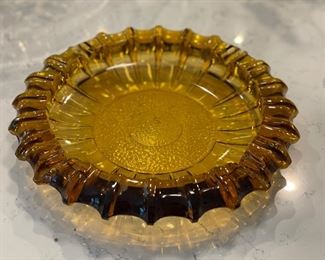 Vintage 10" D amber glass ashtray.