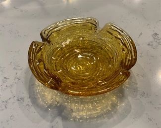 Vintage 4.5" D amber glass ashtray with faux bois pattern.