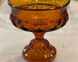 Vintage amber glass coin pattern large footed compote. Measures 5.5" H x 5" D.