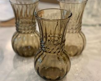 Set of three smoke glass vases. Each measures 6.5" H x 3.25" D.