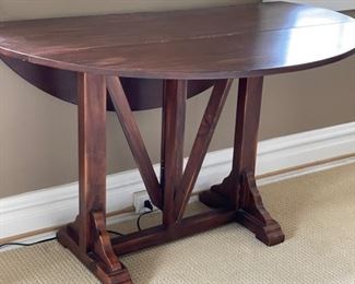 Vintage drop leaf table circa 1940. Measures 46" W x 15" D x 29" H. Extends to 40"D with two 12" drop leaves.
