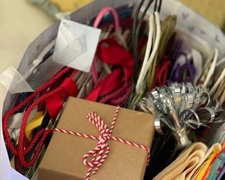 Assorted Christmas wrapping supplies including unopened wrapping paper rolls.