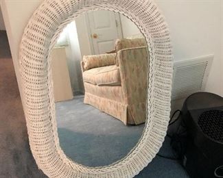 White wicker framed oval wall mirror