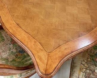 Antique French carved wood game table with parquet top and hidden bid drawers purchased from E. G. Cody. Four cane-back chairs upholstered in Scalamandre toile fabric available, too..  Photo 2 of 5.