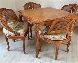 Antique French carved wood game table with parquet top and hidden bid drawers purchased from E. G. Cody. Four cane-back chairs upholstered in Scalamandre toile fabric available, too. Photo 1 of 5.