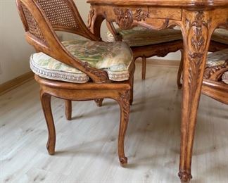 Antique French carved wood game table with parquet top and hidden bid drawers purchased from E. G. Cody. Four cane-back chairs upholstered in Scalamandre toile fabric available, too..  Photo 3 of 5.