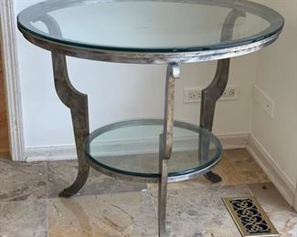 Swaim round silver metal side table with glass top. Measures 34" H  x 30" D. 