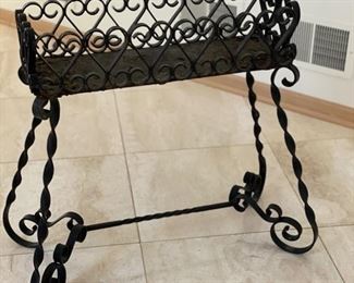 Wrought iron planter - 2 available. Each measures 25" W x 32" H  x 9" D. 