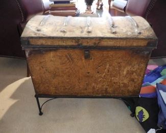 Antique metal trunk on custom-made iron stand