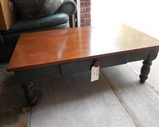 Wood coffee table with dark green legs