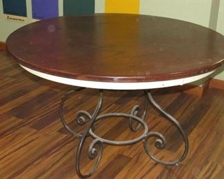 Cherry stained wooden table top with metal scroll base  estimate 48" across  extremely sturdy  $100