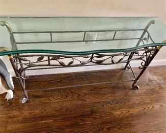 Glass topped console with wrought iron and brass base