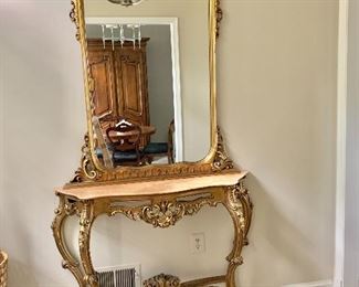 Vintage gilt console with marble top and gilt mirror.