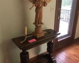 Antique sofa table and large woo carving of angel.