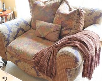 Upholstered Club Chair loaded with Accent Pillows and Throw