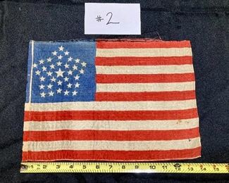 $4000
34-star "Great Star" parade flag commemorating Kansas's statehood in 1861. Screen printed on silk. Top selvedge edge is starting to unravel. Right side and bottom are machine stitched, and left side has full length sewn tube to accommodate a pole.