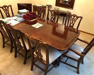 Thomasville double pedestal table with six Chippendale side chairs, two Chippendale arm chairs, and two leaves.