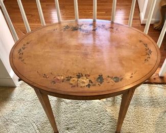 $180  Vintage oval floral side table with bell flower legs.   25" H, 29.5" W, 20.5" D.