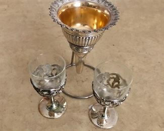 $20 Pair stemmed glasses with silver trim each 4.25" H, 2" diam.  $35 Hanging gilt wash funnel 6" H, 4.25" diam.