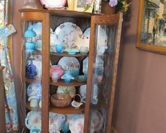 Antique curved glass cabinet with lots of treasures