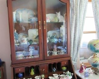 Beautiful secretary with inlaid leather top in wonderful condition.  Filled with treasures including R S Prussia, Rosenthal, Fenton, Royal Doulton and more.