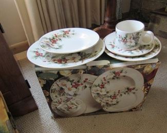4 place settings of Christmas china still in the box
