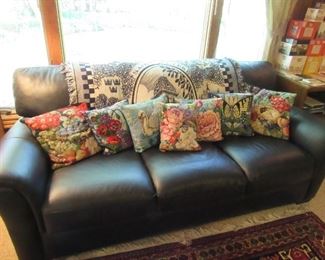 Leather sofa, St Peter afghan and more hand done needlepoint pillows