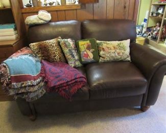 Leather loveseat, vintage afghans and more needlepoint pillows