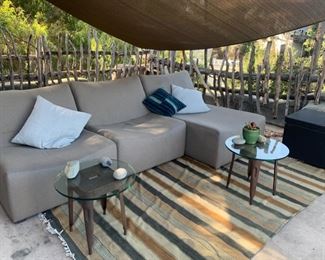 $1500 Sunbrella outdoor fabric upholstered lounger sofa set. *Included 3 upholstered pieces, rug, pillow, 2 small glass top tables, storage bench & shade sail